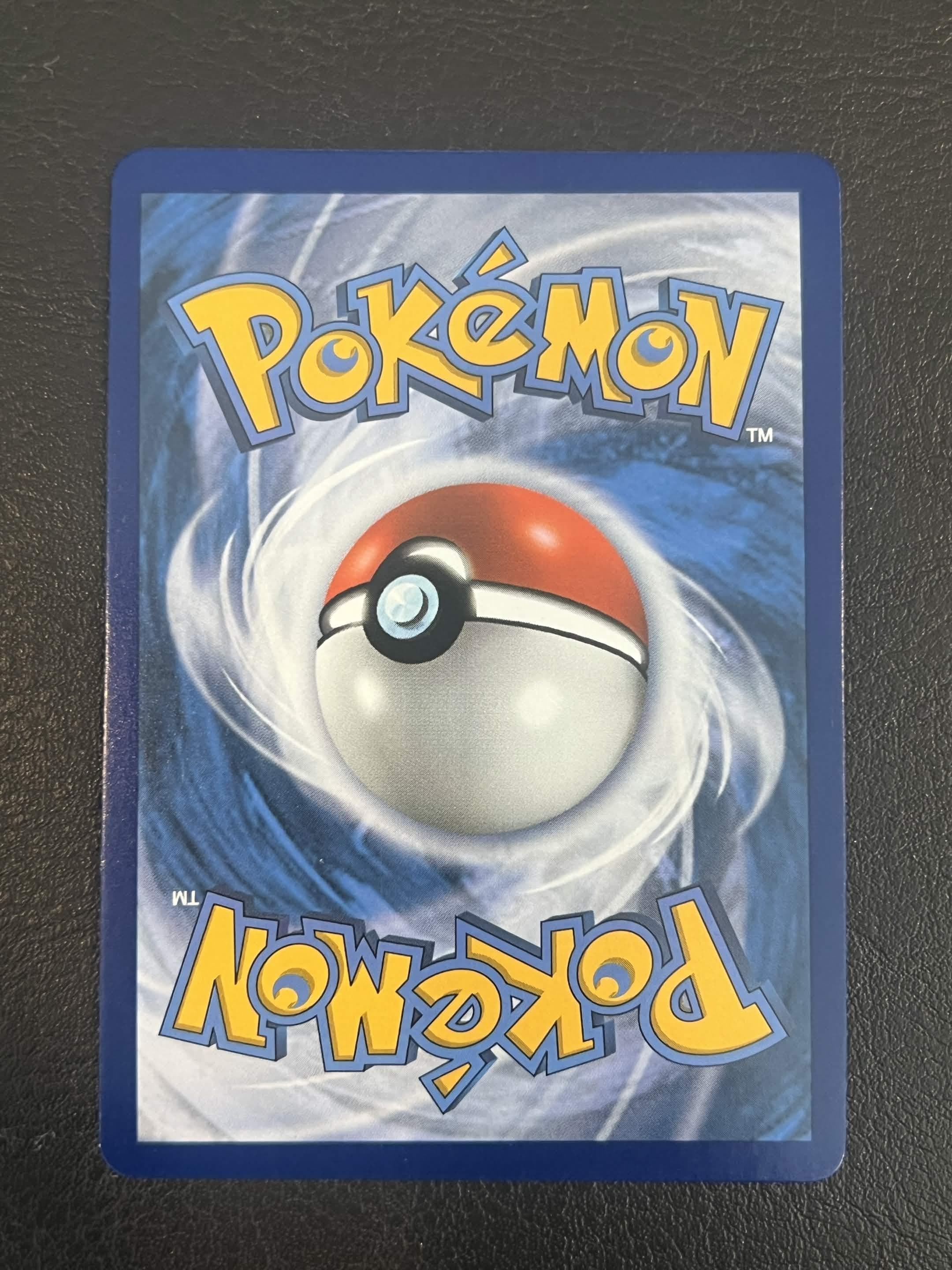 Near Mint Pokémon card back used as a condition reference